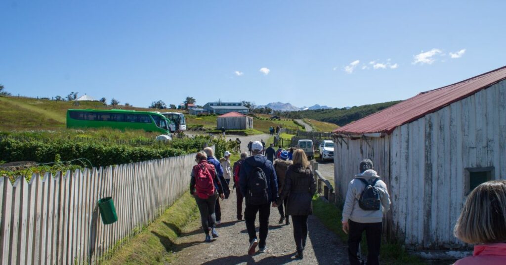 Shutterstock A group of people walk towards several buses standing in the distance