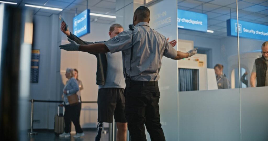 Shutterstock A TSA officer checking a person with a prosthetic leg