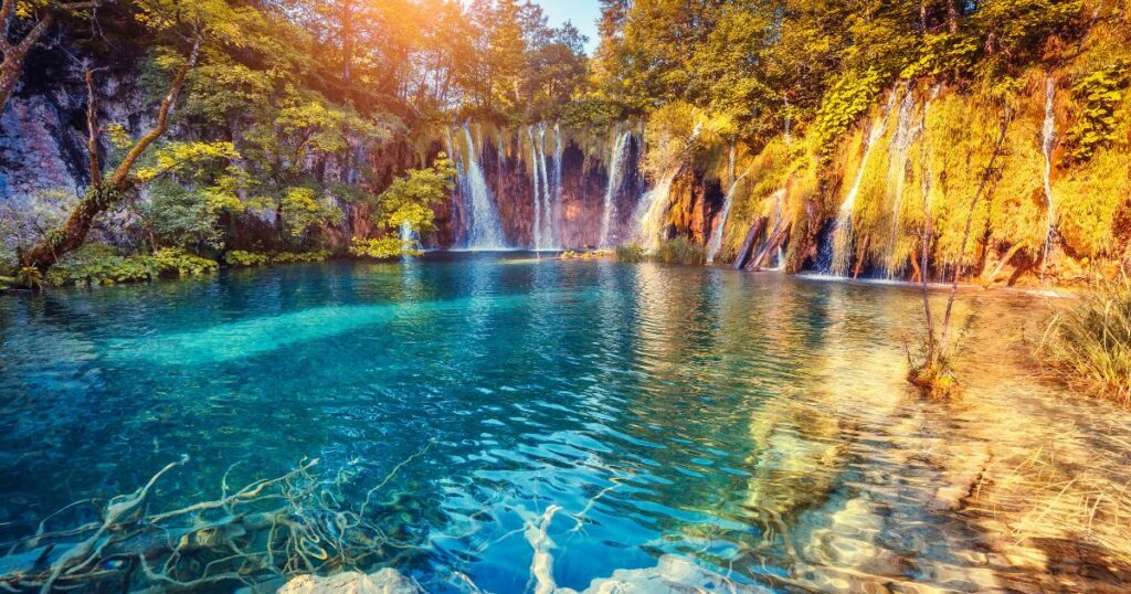 Shutterstock Majestic view on turquoise water and sunny beams in the Plitvice Lakes National Park.