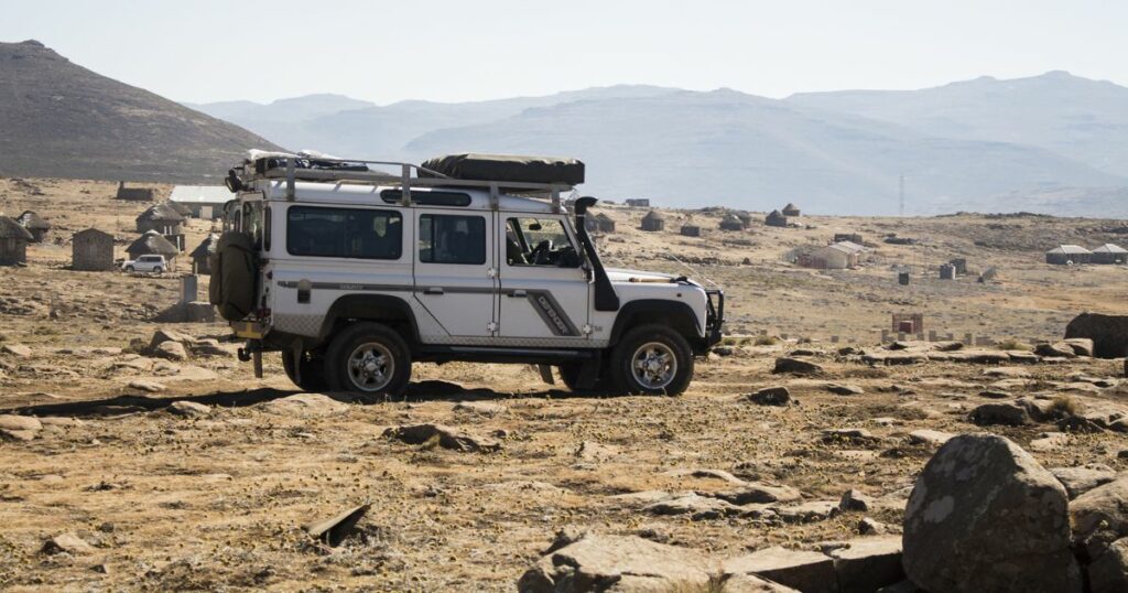 Shutterstock Land Rover Defender is doing off-road trail in Lesotho next to Sani Pass