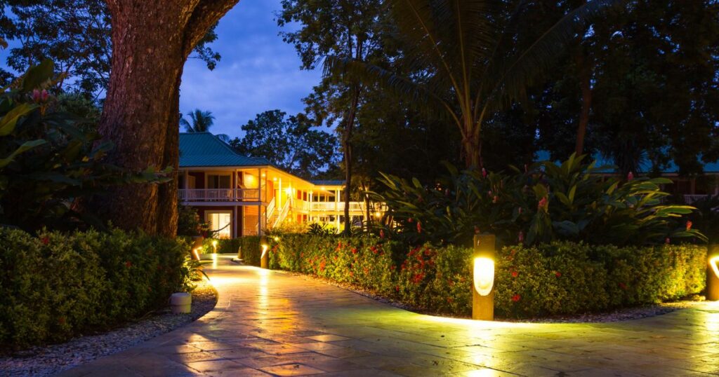 Shutterstock Evening view of the lit path to the hotel rooms in Tambor, Costa Rica