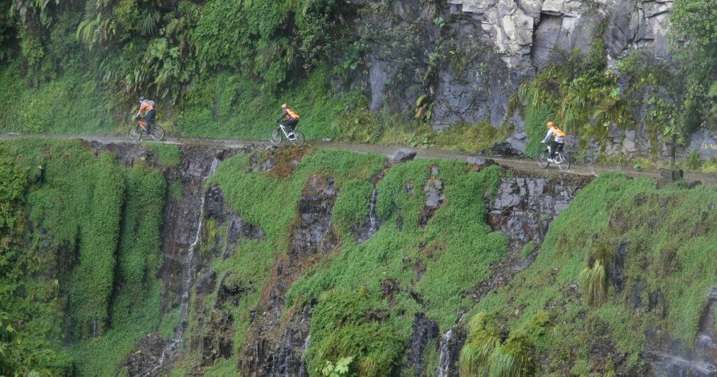 Shutterstock Adventurous bikers riding along the narrow road
