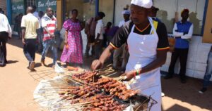 A vendor making traditional African street food