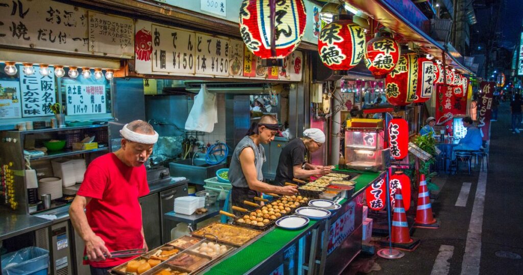 Shutterstock Osaka street vendors making Octopus balls