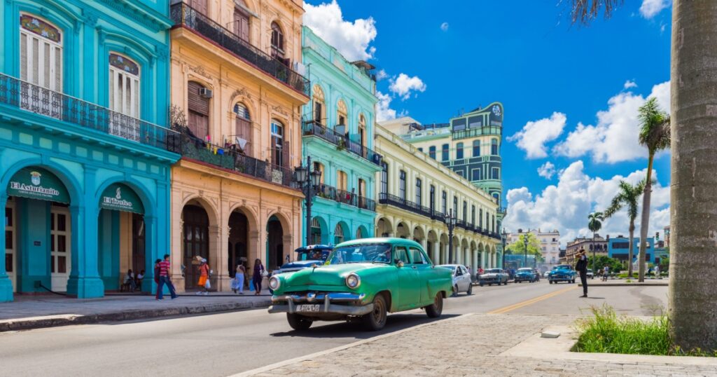 American green Chevrolet classic car drives on the main road in Havana Cuba City before the Capitolio - Serie Cuba Reportage