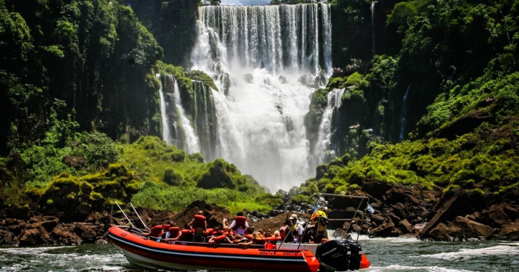 Speed boat rides under the water cascading over the Iguacu falls in Iguacu, Brazil