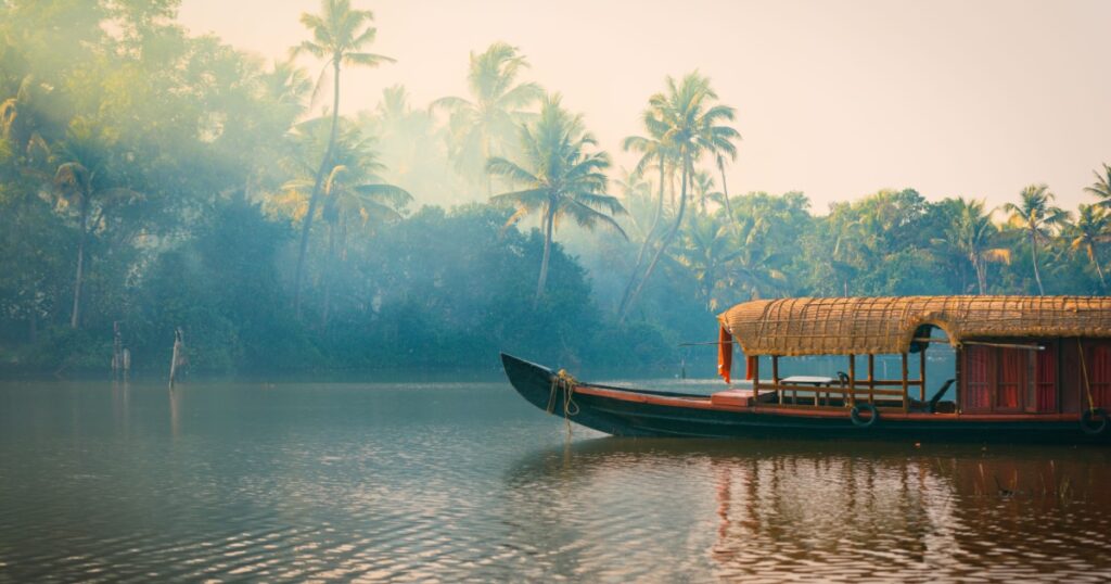 A traditional house boat is anchored on the shores of a fishing lake in Kerala, India
