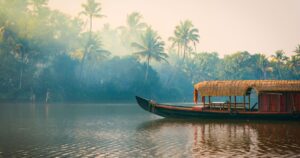 A traditional house boat is anchored on the shores of a fishing lake in Kerala, India