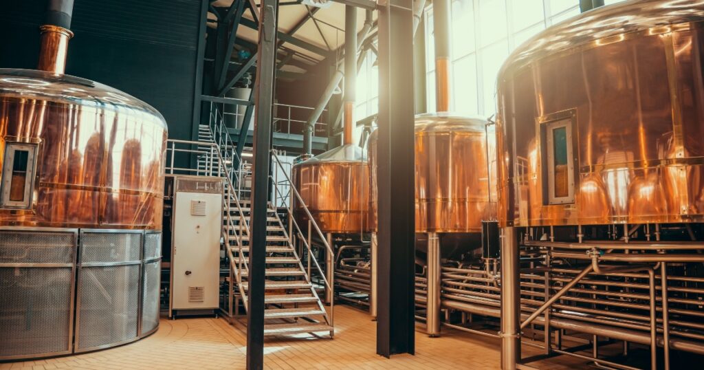 Brew manufacturing. Round cooper storage tanks for beer fermentation and maturation