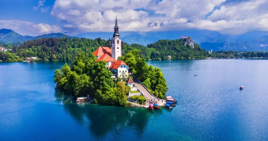 Amazing Bled Lake, island and church with Julian Alps mountain range background, Europe spotlight