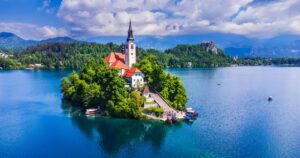 Amazing Bled Lake, island and church with Julian Alps mountain range background, Europe spotlight