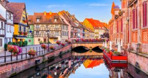 View with colorful buildings, canal and flowers. Colmar, France. Petite Venice