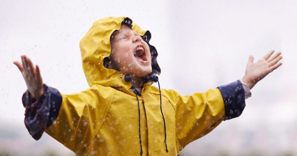 Girl, playing outdoor and screaming in rain