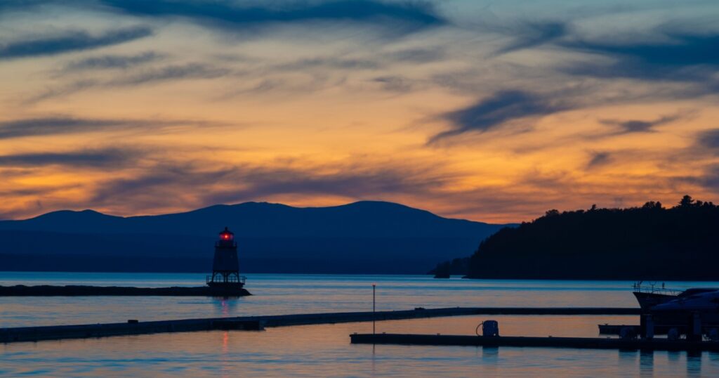 Colorful view at dusk of North Lighthouse and Breakwater in Lake Champlain from Burlington, Vermont.