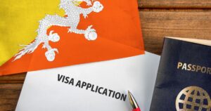Visa application form, passport and flag of Bhutan