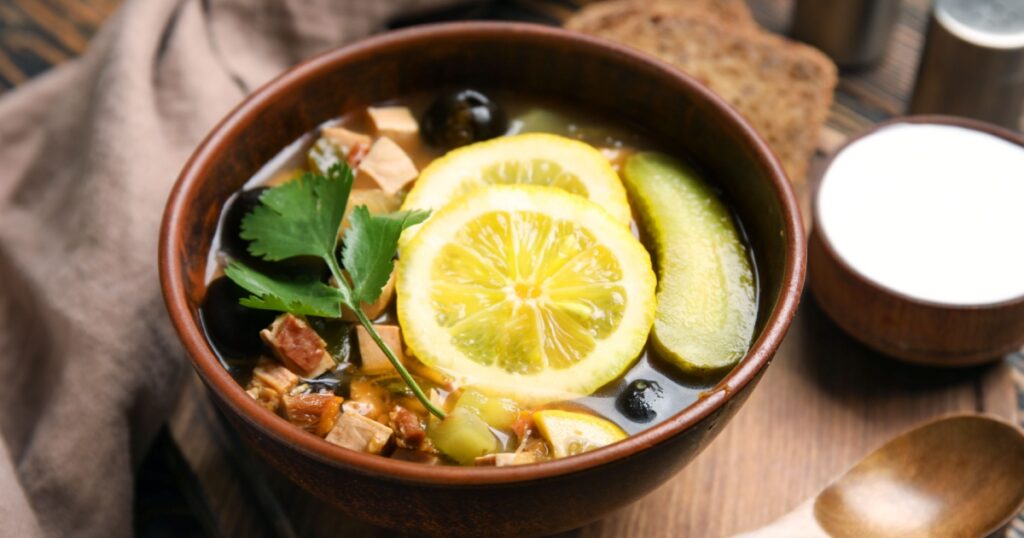 Bowl of tasty Hodgepodge soup on table