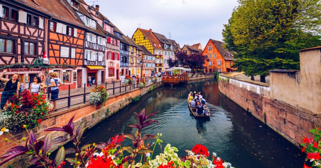 Shutterstock Old town of Colmar, Alsace, France. View with colorful buildings, canal and flowers.