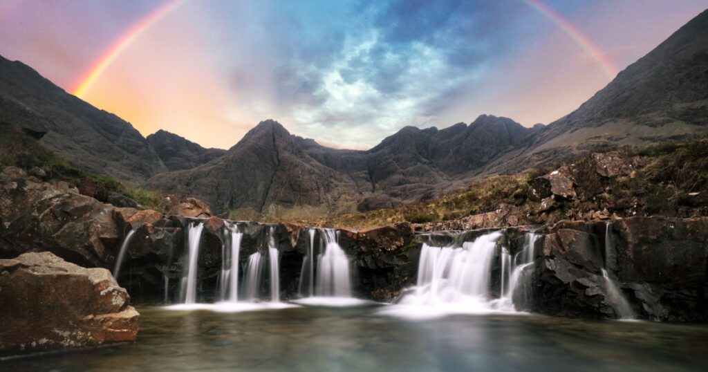 Scotland - Rainbow over Fairy pools waterfall in Isle of Skye, UK