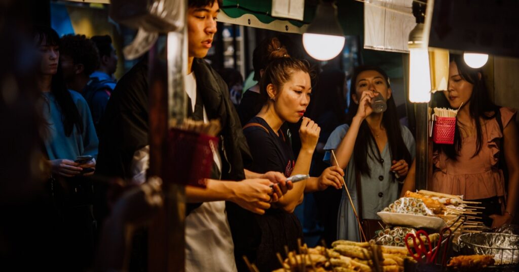 People at a stall on a busy street food