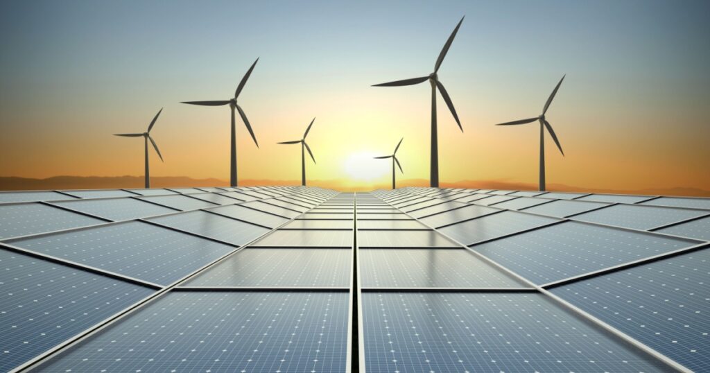 Solar power plant and wind turbines at beautiful sunset background
