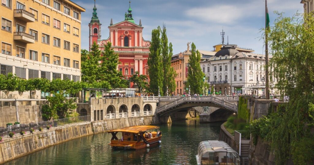 River Ljubljanica, Triple Bridge - Tromostovje, Preseren square and Franciscan Church of the Annunciation. Ljubljana Slovenia Europe.