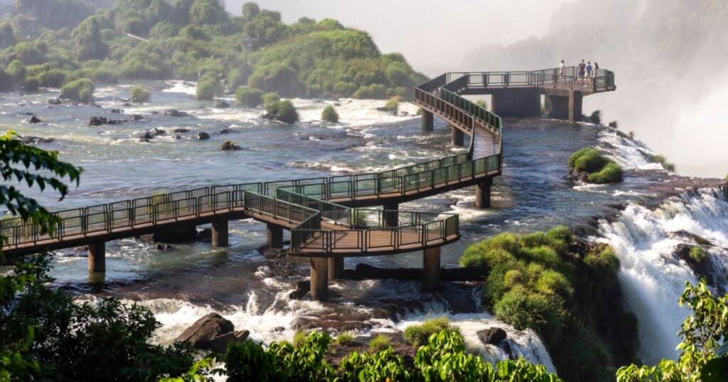 Beautiful view to walking path over green rainforest waterfalls in Iguaçu Falls