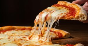 Delicious pizza margherita with melted mozzarella cheese