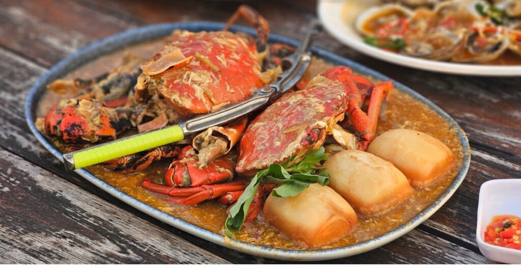 Fresh seafood Chilli crab Singapore style serving with fried bun on the timber table