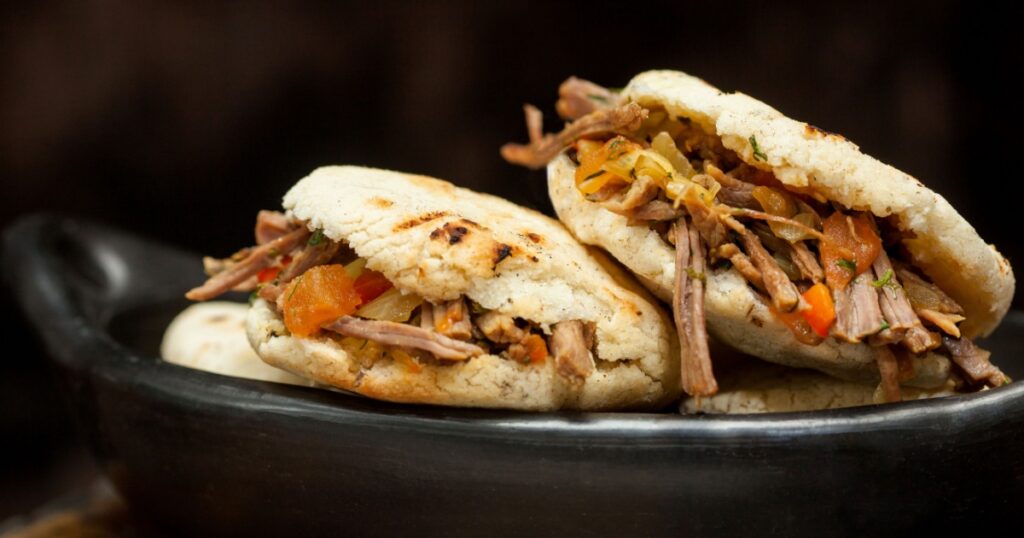 Traditional Colombian arepa filled with shredded beef