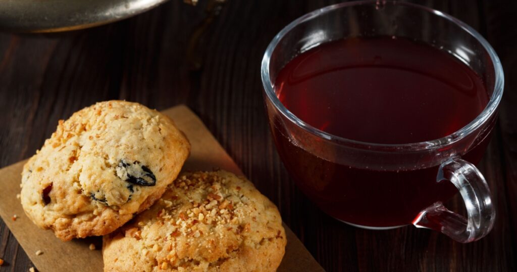Homemade oatcakes with a dried fruit drink, close view.