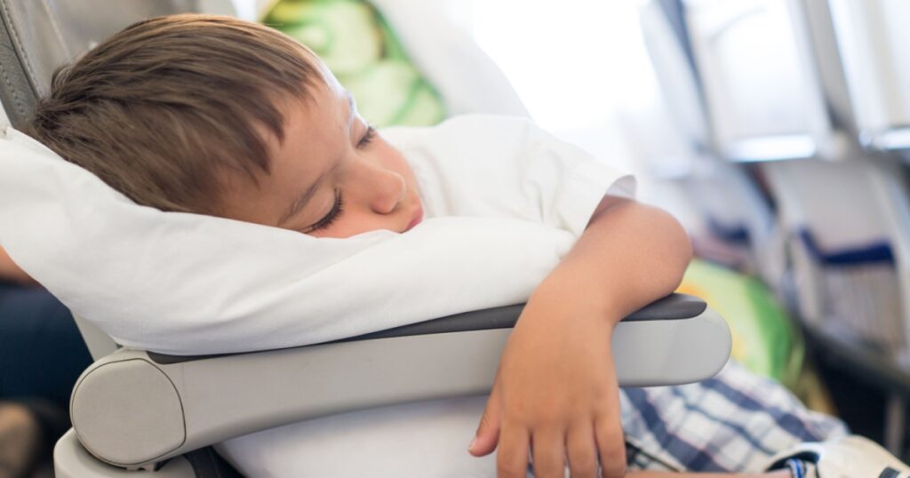 Kid sleeping inside the airplane during the flight