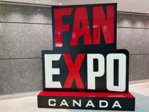 A large red and white text sign that reads "FAN EXPO Canada"