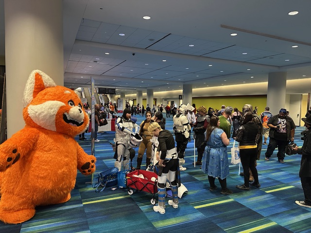 A large red panda mascot stands alongside a group of cosplayers dressed as Star Wars characters at Fan Expo Canada.