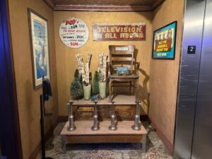 Vintage corner display at Pike’s Waterfront Lodge featuring antique barber shop signage, a wooden shoe shine stand, and nostalgic décor evoking early Alaskan history.