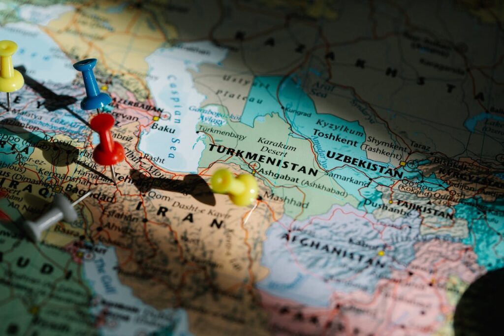 Close-up of a map of Central Asia with push pins marking countries including Turkmenistan, Uzbekistan, and Tajikistan.