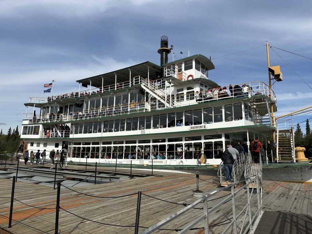 Riverboat Discovery docked on the Chena River in Fairbanks, Alaska, preparing to take passengers on a historic steamboat tour.