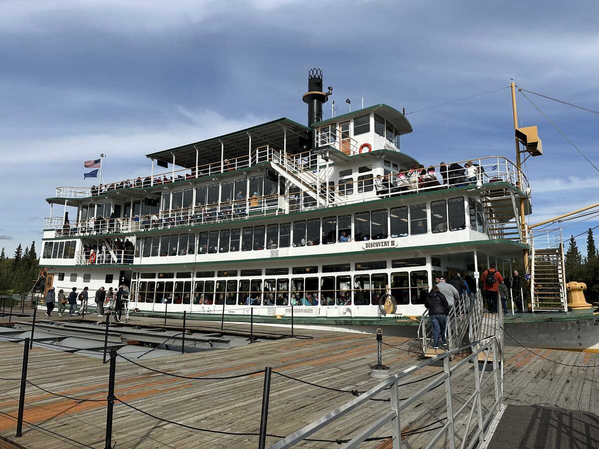 Riverboat Discovery docked on the Chena River in Fairbanks, Alaska, preparing to take passengers on a historic steamboat tour.