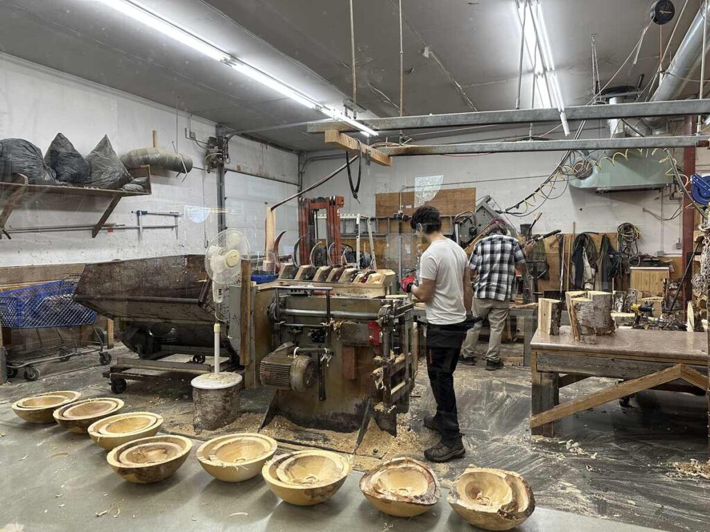 Workshop view showing artisans working on Alaskan birch bowls in progress at the Alaskan Bowl Company in Fairbanks.