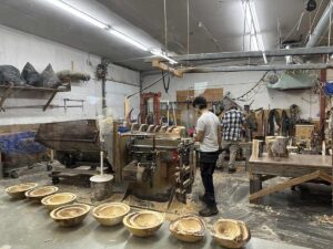 Workshop view showing artisans working on Alaskan birch bowls in progress at the Alaskan Bowl Company in Fairbanks.