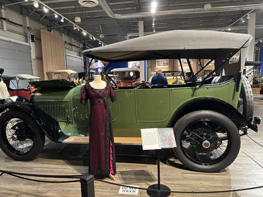 A 1910s-style gown displayed beside a vintage car at the Fountainhead Antique Auto Museum in Fairbanks. This exact dress inspired the red and black gown worn by Kate Winslet’s character Rose in the film Titanic