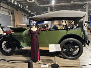 A 1910s-style gown displayed beside a vintage car at the Fountainhead Antique Auto Museum in Fairbanks. This exact dress inspired the red and black gown worn by Kate Winslet’s character Rose in the film Titanic