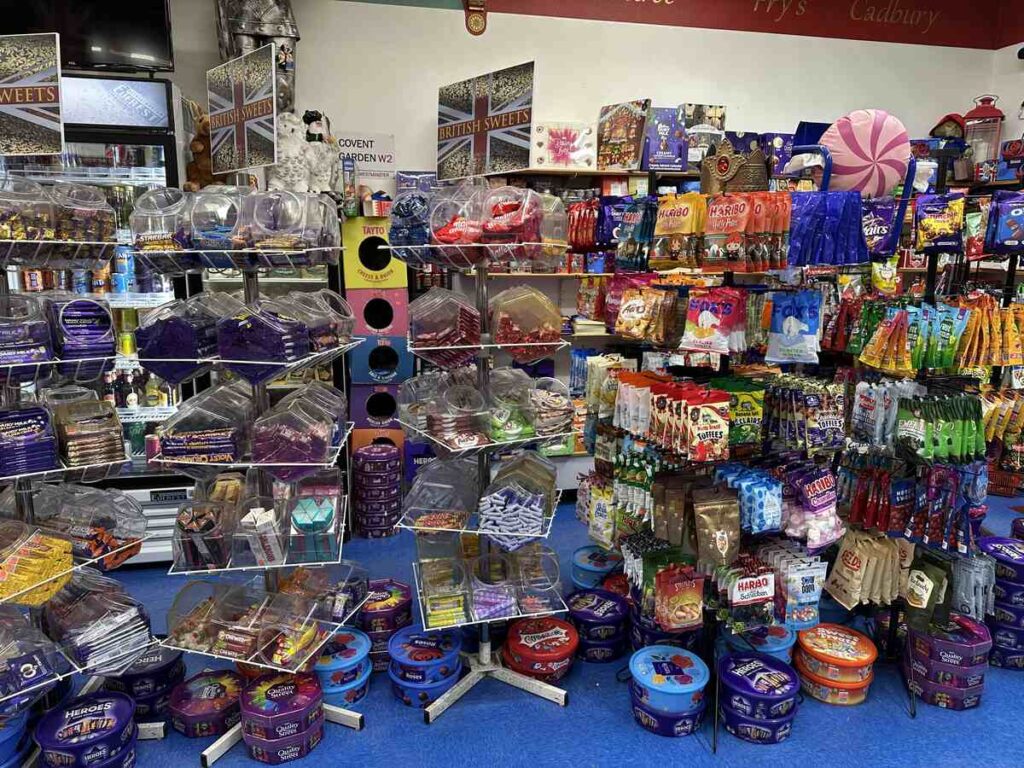 Display of British sweets at the British Emporium, with tubs and racks filled with chocolate bars, toffees and colourful bags of candy.