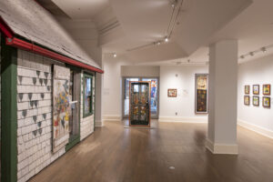 Interior gallery space at the Art Gallery of Nova Scotia featuring Maud Lewis’s painted house and folk art.
