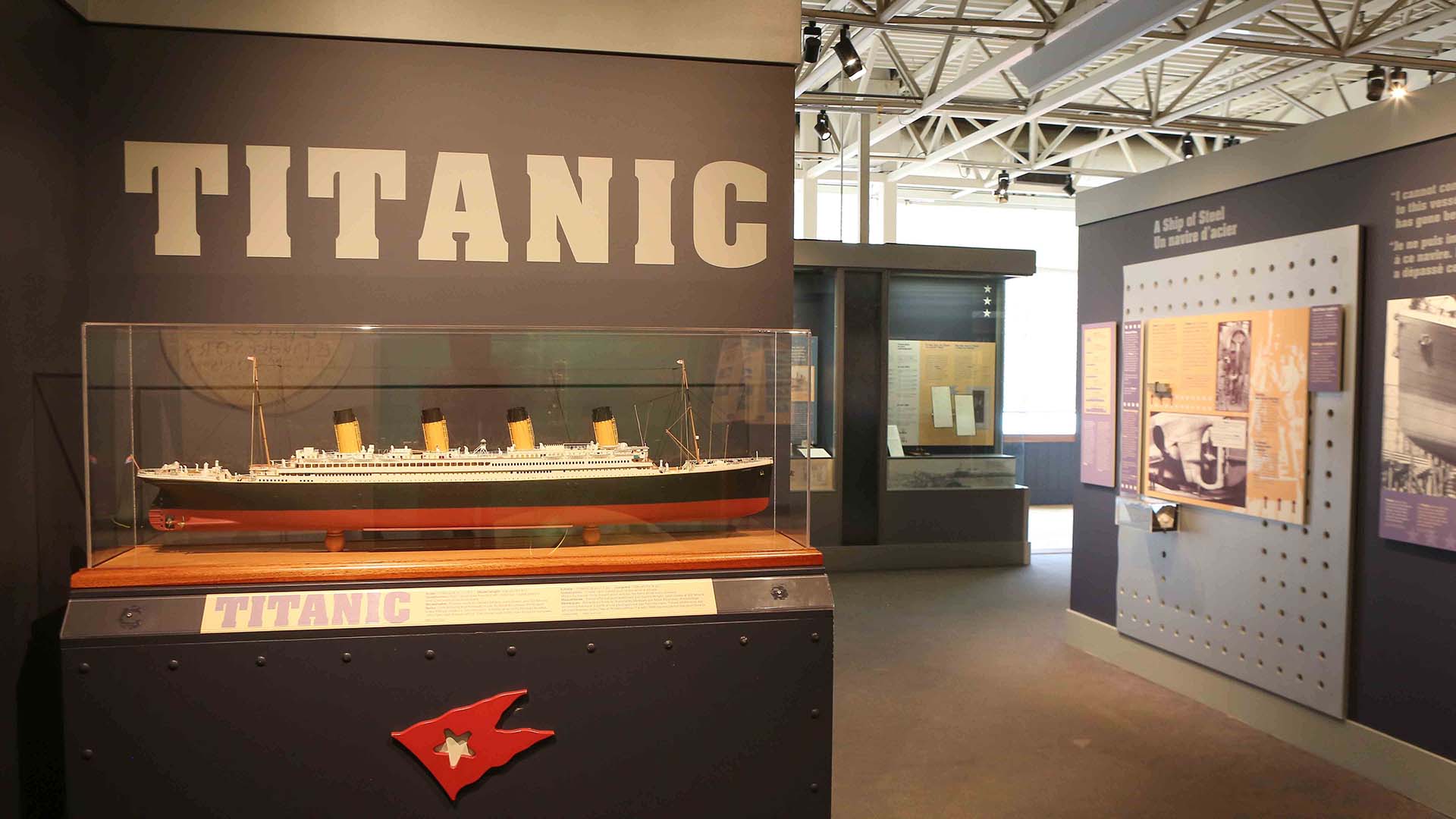 Interior view of the Titanic exhibit at the Maritime Museum of the Atlantic, featuring a large model of the ship and interpretive display panels.