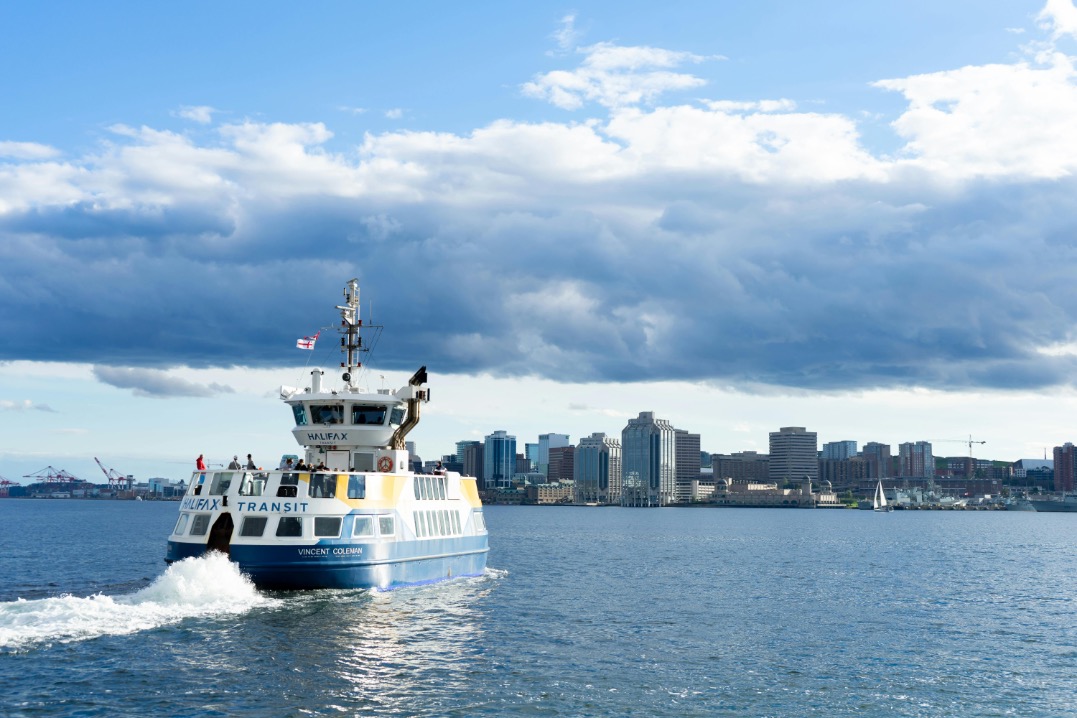 Halifax Transit ferry crossing the harbour with the downtown skyline in the background.