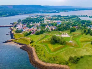 erial view of Annapolis Royal and the waterfront, with Fort Anne’s grassy earthworks in the foreground and water on both sides.