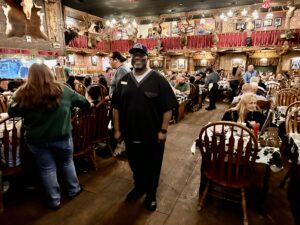 Tony Love, known as Dr. Love, standing inside The Big Texan Steak Ranch dining room in Amarillo, Texas.