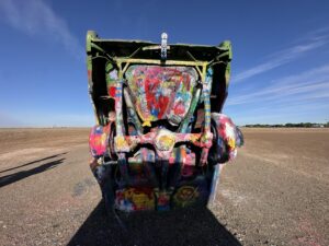 Close-up of a spray-painted Cadillac at Cadillac Ranch in Amarillo, Texas, covered in layers of colourful paint.