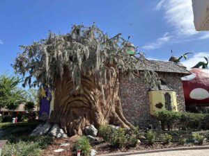 Large tree sculpture and whimsical buildings at Give Kids The World Village in Kissimmee, Florida.