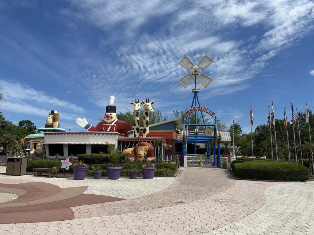 Amberville play area at Give Kids The World Village with colourful animal figures and a windmill.